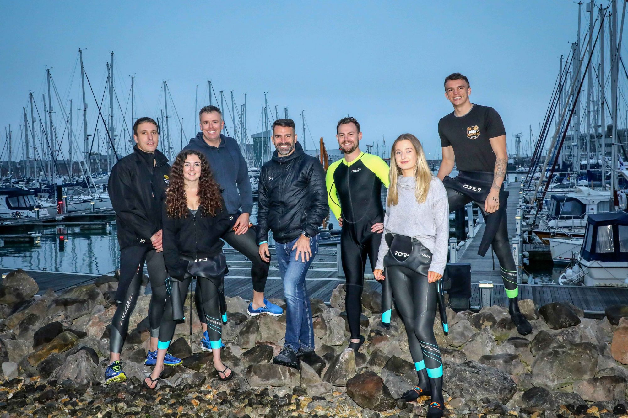 AT THE READY: Employees of Trant Engineering took part in a charity swim across the Solent from Gosport to Ryde, Isle of Wight, with a pep talk by Saints legend Francis Benali, centre. From left, James Henderson (Director – Process and Water), Jess Howe (Buyer), David Graham (Framework Manager), Terry Elstone (Consultant Commercial Manager), Louisa Davies (Quantity Surveyor) and James Stead (Project Engineer).